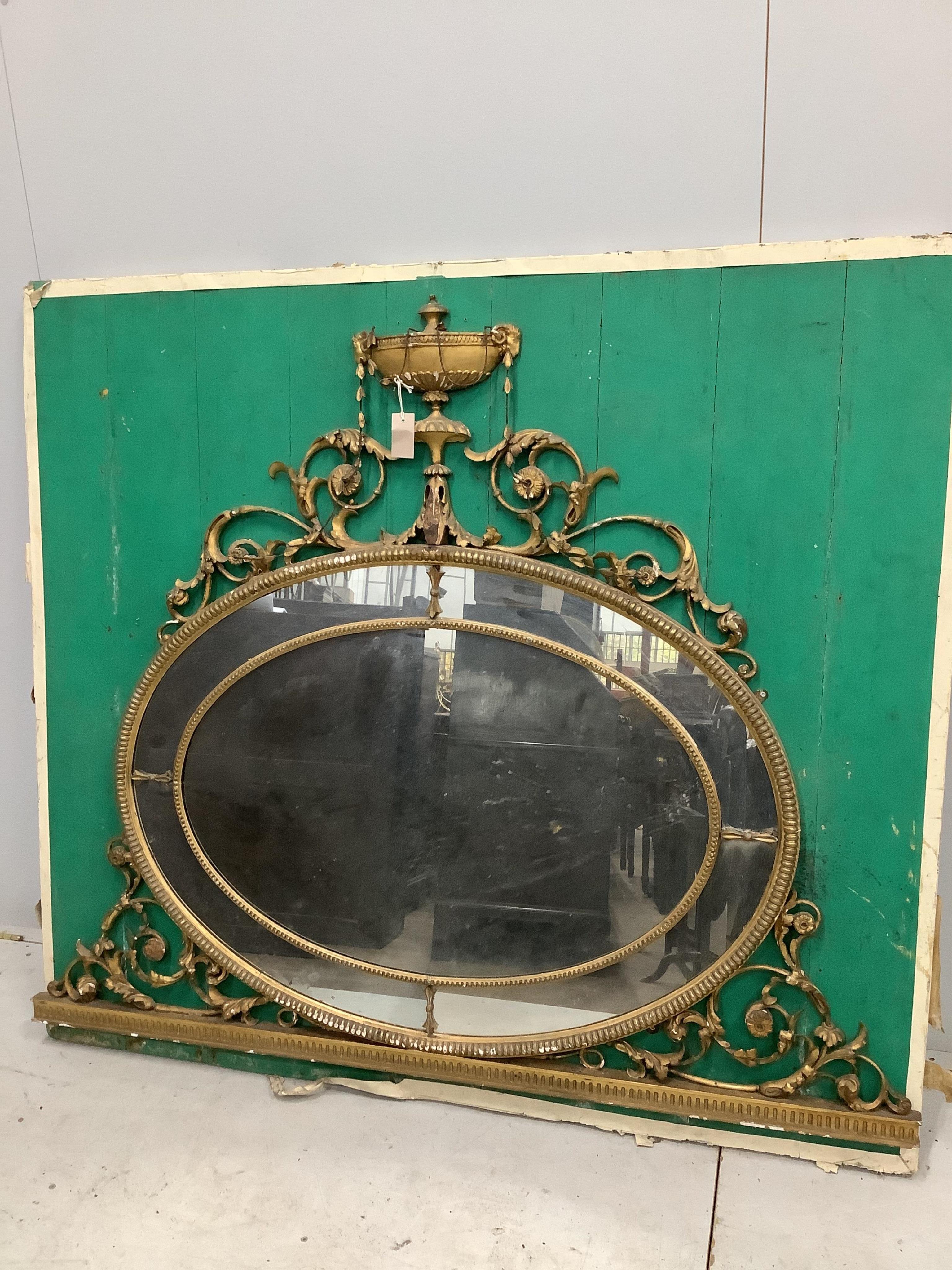 A Victorian oval giltwood and composition wall mirror, width 152cm, height 157cm. Condition - poor to fair